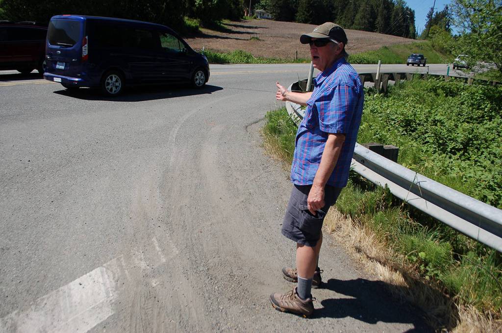 Richard Bloomer describes the tricky detour around the washed-out Dean Creek Bridge that takes bicyclists onto the U.S. Highway 101 shoulder. Sequim Gazette photo by Conor Dowley.