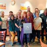Staff members at Quality Inn & Suites at Olympic National Park join general manager Nancy Merrigan, center, in celebrating the hotels 2019 Platinum Award. Submitted photo