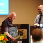 Vern Elkhart, left, accepts an award from Travis Simmons at United Way of Clallam Countys annual Campaign Celebration at The Cedars at Dungeness on May 9. Elkhart accepted the award on behalf of his wife Claudia Mrs. K Elkhart, a longtime Port Angeles librarian who inspired the United Ways Bowling for Books fundraiser in August 2018. (Claudia Elkhart died in September 2017). Sequim Gazette photo by Michael Dashiell