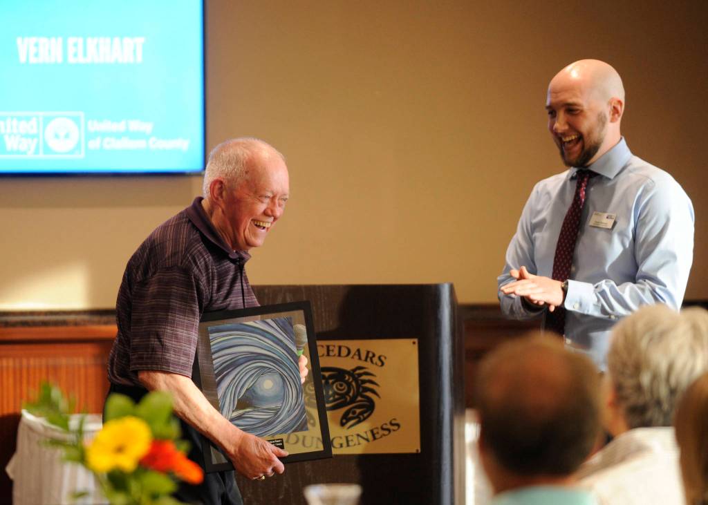 Vern Elkhart, left, accepts an award from Travis Simmons at United Way of Clallam Countys annual Campaign Celebration at The Cedars at Dungeness on May 9. Elkhart accepted the award on behalf of his wife Claudia Mrs. K Elkhart, a longtime Port Angeles librarian who inspired the United Ways Bowling for Books fundraiser in August 2018. (Claudia Elkhart died in September 2017). Sequim Gazette photo by Michael Dashiell