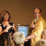 Pepper Fisher, on-air announcer for Newsradio KONP, accepts an award from Lori Taylor of United Way of Clallam County on May 9. Sequim Gazette photo by Michael Dashiell
