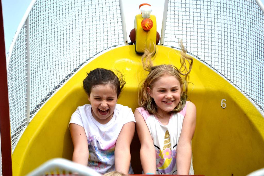Addy Thomas, 8, of Sequim, left, and London Wilkinson, 9, of Port Angeles, soar back and forth on a pirate ship during the carnival on May 12. The girls said the ride was really cool. Sequim Gazette photo by Matthew Nash