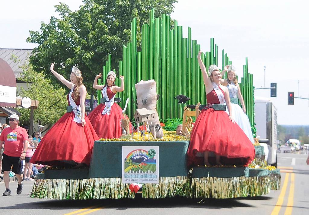 Sequim Irrigation Festival royalty  from left, princesses Brianna Cowan, Kjirstin Foresman and Shelby Wells and queen Emily Silva  wave to an adoring crowd at the 2019 Grand Parade on May 11. Sequim Gazette photo by Michael Dashiell