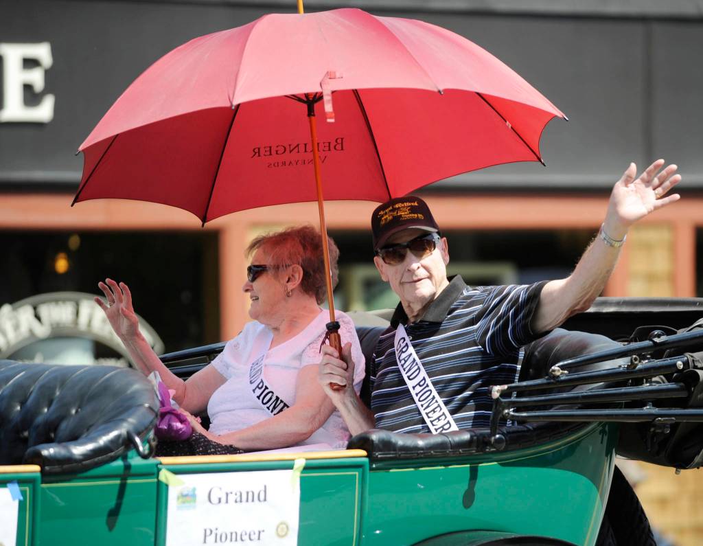 Bruce and Barbara Fernie, 2019 Sequim Irrigation Festival Grand Pioneers, wave to the crowd at Saturdays Grand Parade. Sequim Gazette photo by Michael Dashiell
