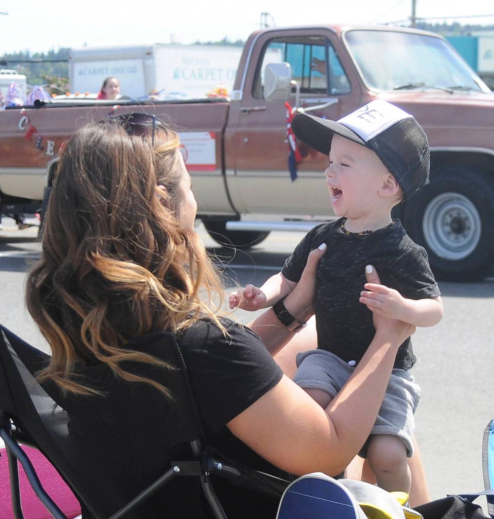 Ellis Hueter and mom Meghan enjoy the Sequim Irrigation Festival Grand Parade on May 11. Sequim Gazette photo by Michael Dashiell