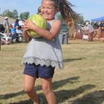 Monroe Nichols, 5, of Sequim, is all smiles after getting her hands on a watermelon that was spared a smashing fate at the Sequim Irrigation Festival Logging Show on May 11. Sequim Gazette photo by Michael Dashiell
