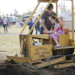 Nelson Bekkevar helps Adalie Eastburn, 9, of Sequim, move a bit of dirt at the Sequim Irrigation Festival Logging Show on May 11. Sequim Gazette photo by Michael Dashiell