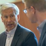 Olympic Medical Center CEO Eric Lewis tells Kilmer of the impacts the Centers for Medicare and Medicaid Services cuts to Medicare reimbursements will have on the hospital. (Jesse Major/Peninsula Daily News)