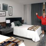 Jerry Allen, chief executive officer for 7 Cedars Casino, describes the choice of decor Saturday in a mockup guest room that will be typical of the guess offerings in a resort hotel under construction in Blyn. (Keith Thorpe/Peninsula Daily News)