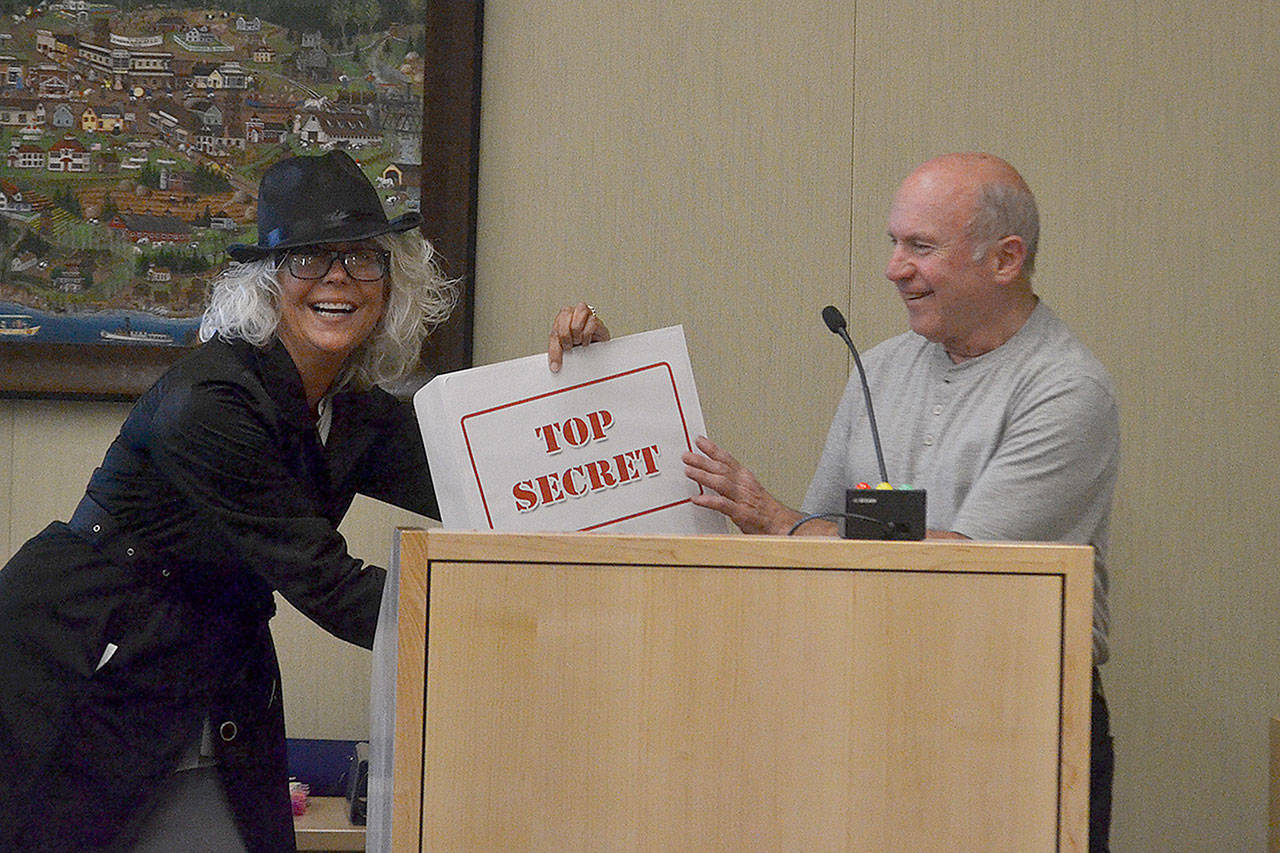 Sue Hagener, Sequim administrative services director, presents top secret results from The Peoples Project! to Sequim Mayor Dennis Smith on May 13. This year, 951 people mostly voted for new water fountains and automated garbage cans. Sequim Gazette photo by Matthew Nash