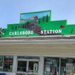 Port Angeles artist David Latimer recently recreated a mural for the Carlsborg Station. He remade a mural by the late Tim Quinn for the stations owners Jim and Julie Schumacher. Submitted photo