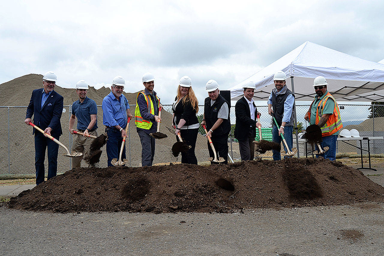 For the ceremonial first dig of the West Fir Street Rehabilitation Project, dignitaries scoop dirt on May 16 after a ceremony commemorating the start of year-long construction from Sequim Avenue to Fifth Avenue. Digging in are, from left, Sequim Schools superintendent Gary Neal, Sequim City Manager Charlie Bush, Sequim Public Works Director David Garlington, Sequim City Engineer Matt Klontz, Sequim-Dungeness Valley Chamber of Commerce Executive Director Anji Scalf, Sequim Mayor Dennis Smith, Transportation Improvement Board Executive Director Ashley Probart, Clallam County Commissioner Mark Ozias, and Interwest Construction Operations Manager Bob Reick. Sequim Gazette photo by Matthew Nash