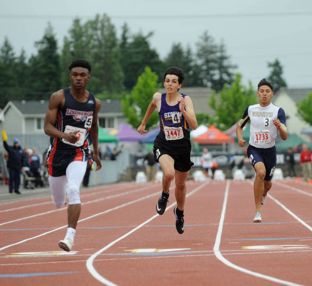 Sequim High junior Darren Salazar, center, earns a spot in the 100-meter finals at the state 2A track and field championships in Tacoma on May 24. Salazar went on to earn two individual medals, placing fifth in the 200 and sixth in the 100. Sequim Gazette photo by Michael Dashiell