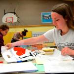 Amanda Weller, 15, writes names on bags for Helen Haller Elementarys Six Books for Summer program on May 22. Weller was one of many Sequim High students with its Interact Club helping students and parent volunteers bag and sort thousands of books. Sequim Gazette photo by Matthew Nash