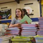 Emma Gilliam, 11, looks for her next book to sort and bag for a second grader as part of Helen Haller Elementarys Six Books for Summer program. Its the third year for the program with funding coming from Helen Haller PTO and community support.