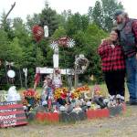 Kim and Don Bedinger look over a roadside memorial that was erected in memory of their 19-year-old daughter, Brooke, who was killed while riding her motorcycle near the spot where U.S. Highway 101 crosses Morse Creek east of Port Angeles. (Keith Thorpe/Peninsula Daily News)