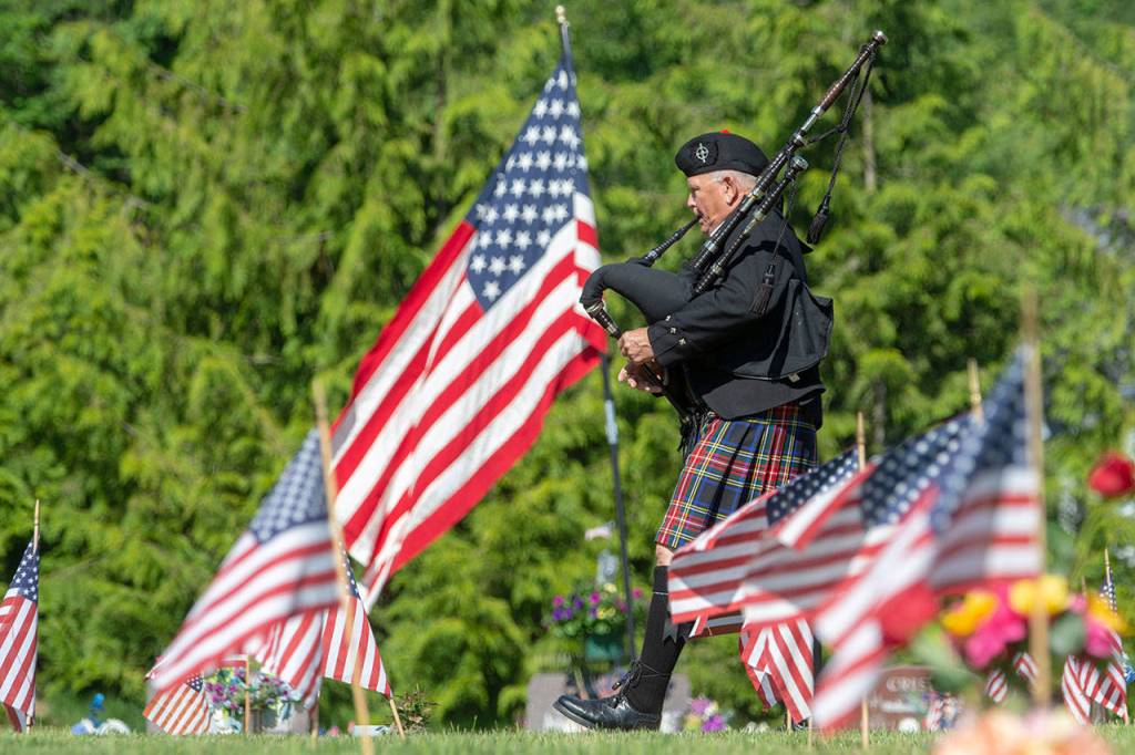 Dr. Tom McCurdy performs bagpipes during the annual Memorial Day service in Port Angeles Monday. Photo by Jesse Major/Peninsula Daily News