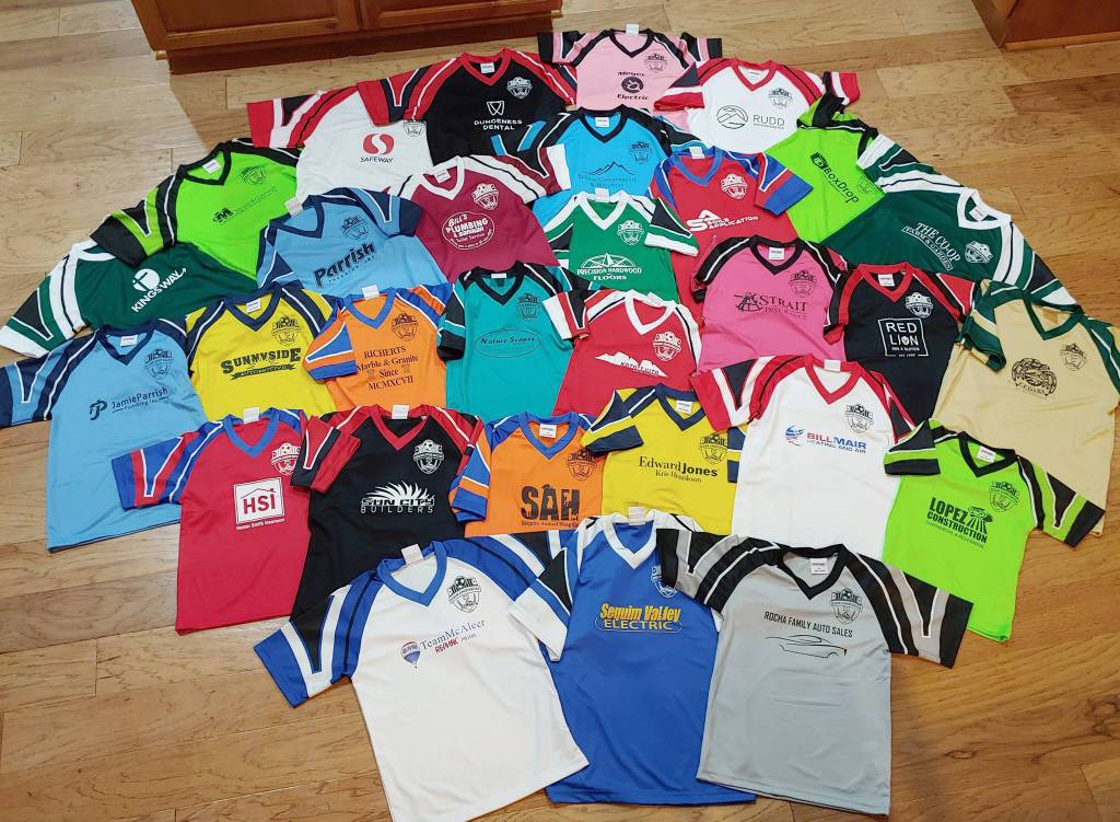 Sequim Junior Soccers team shirts are displayed, showing various local sponsorships. Photo provided by David Henderson.