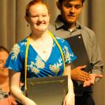 Heidi Schmitt, a Sequim High graduate-to-be, is all smiles after principal Shawn Langston announces her scholarships to Linfield College  a list that includes a Linfield College Presidential Scholarship worth $100,000. Sequim Gazette photo by Michael Dashiell