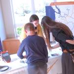 A family gets more information on PNNLs fish tracking and monitoring programs at the STEM Night event at Sequim High School on May 28. Sequim Gazette photo by Conor Dowley.