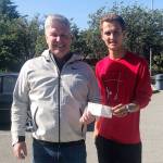 Bill Shea, Director of Golf/general manager at The Cedars at Dungeness, presents funds raised from the 2019 Golf 4 Grads tournament to Liam Payne, Sequim High School senior class vice president. Submitted photo