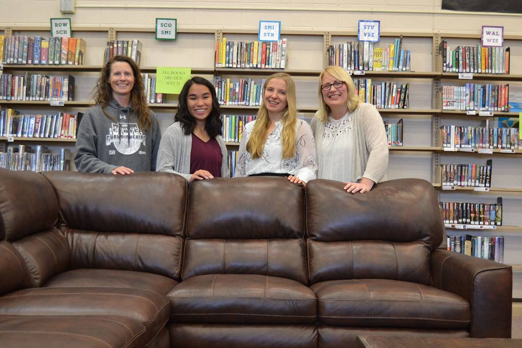 After raising $6,000 for new furnishings under the Robby Streett Legacy Fund, new tables, chairs and coffee tables went into the Sequim High School Library on June 4. There for the installation were, from left, Linsay Rapelje, SHS librarian, Lesae Pfeffer, Annabelle Armstrong, and Josslyn Streett, Robbys mom. Sequim Gazette photo by Matthew Nash