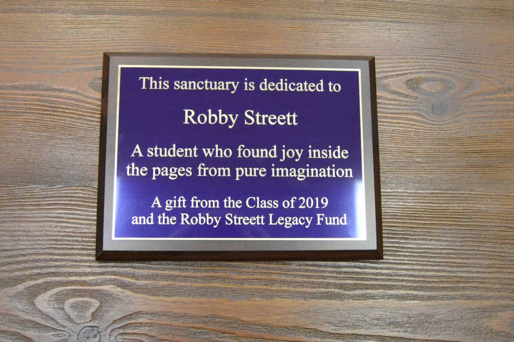 In early 2018, Annabelle Armstrong, left, and Lesae Pfeffer began fundraising to honor the memory of Robby Streett, who died in July 2017 in a car wreck. He would have graduated from Sequim High School on June 7. Here, Armstrong and Pfeffer hold a plaque donated by the Class of 2019 dedicated to Robby. Sequim Gazette photo by Matthew Nash