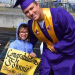 Sequim High School graduate-to-be Johnnie Young gets encouragement from Camryn Corbin, a first-grader in Kelly Millers Helen Haller Elementary School class, during the Graduation Walk event on June 7. Young graduated later that day at SHSs commencement ceremony. Submitted photo