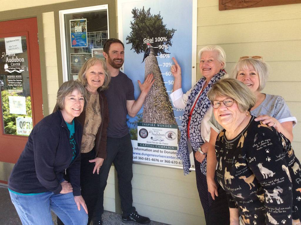 The woodpecker climbs again: Representatives of the volunteer Capital Campaign Committee raising funds for the proposed Dungeness River Audubon Center expansion include, from left, Darcy McNamara, chair Annette Hanson, center director Powell Jones, Kendra Donelson, Wanda Schneider and Tuttie Peetz. Here they stand in front of the Inspire Wonder Capital Campaign banner  now at about 90 percent (as marked by the woodpecker) of the approximate $3.6 million goal after recently receiving word of a $1.5 grant through a State Capital Budget appropriation. Submitted photo