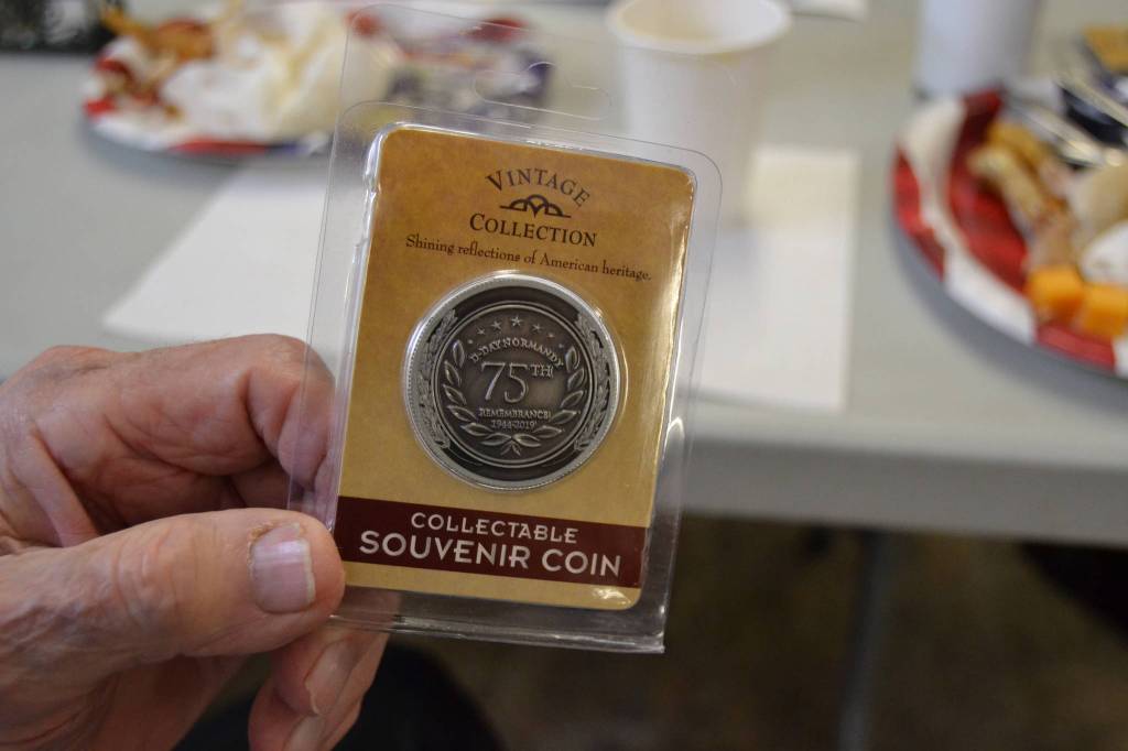 June 6 was the 75th anniversary of D-Day, the invasion of Normandys beaches during World War II. To honor the occasion, VFW Post 4760 members handed out special coins. Sequim Gazette photo by Matthew Nash