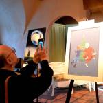 Steven Humphrey, musical director for Another Night Before Christmas snap a shot of art created for the show by Gail McLain. The art piece will be raffled off during its run Dec. 13-22. Sequim Gazette photo by Matthew Nash