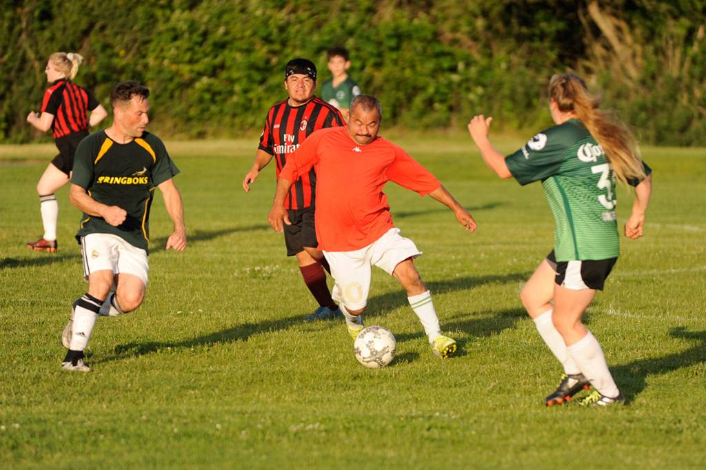 Bandidos Sergio Yanez of Sequim drives past members of Pura Vida during Sequim FCs championship game on June 12 at the Albert Haller Playfields. Yanez scored the final goal of the day to help the Bandidos win 4-2. Sequim Gazette photos by Matthew Nash