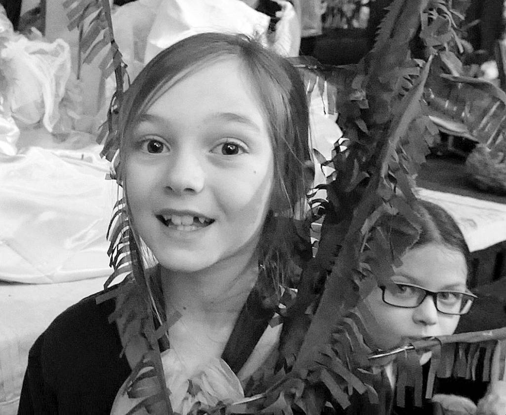 At left, Josepha Johnson, 9, and Lillian Anderson, 10, play tube worms in the tide pools of The Tidepool Times. Photo courtesy of Olympic Theatre Arts
