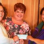Celebrating a recent donation from WeDo Fudge to the Sequim Irrigation Festival are, from left, festival director Deon Kapetan, kickoff dinner/auction organizer Robin Bookter and Christina Norman of WeDo Fudge. Submitted photo