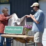 Andra Smith and Mark Ozias, current and former executive director for the Sequim Food Bank, reveal a sign naming a building after long-time board president and volunteer Stephen Rosales. I think what the food bank becomes from here on out is really going to be a testament to the vision Stephen has brought to us and this organization over the course of time, Ozias said. Sequim Gazette photos by Matthew Nash