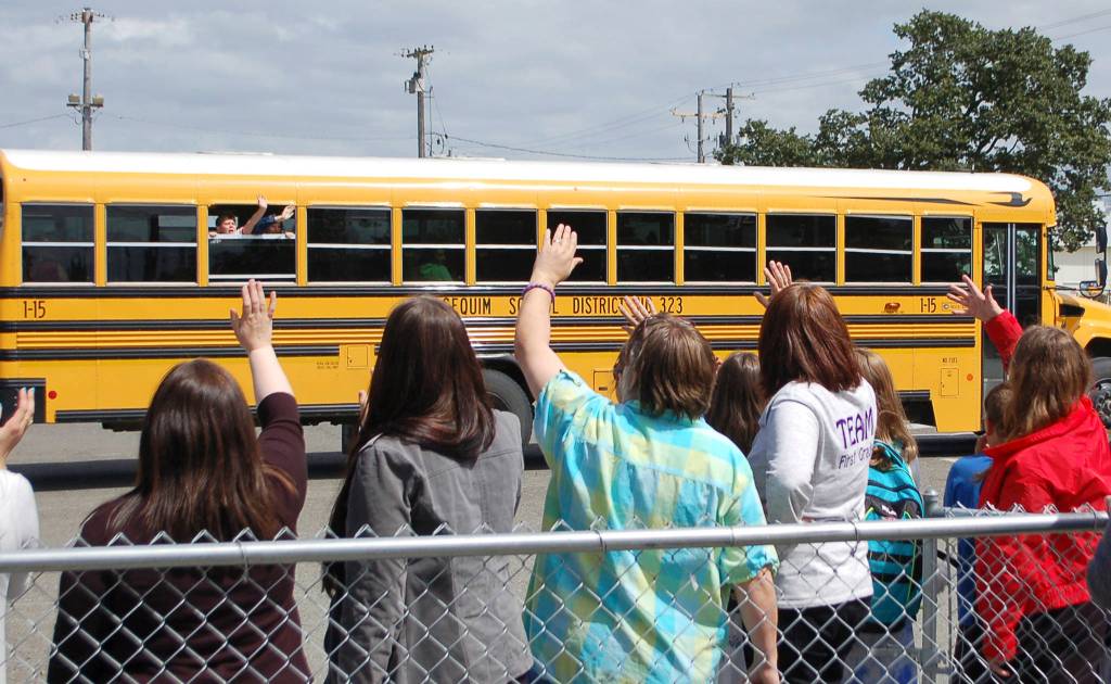 Sequim schools staff wave goodbye to students on the final day of school, June 19. Sequim Gazette photo by Conor Dowley