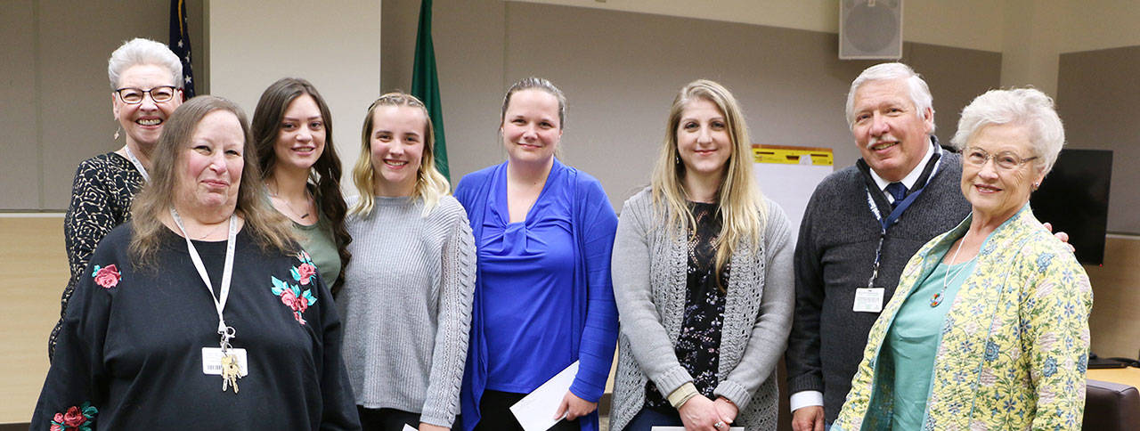 Pictured, from left, are: Patty Glennon, OMC Auxiliary scholarship committee chair; scholarship committee member Sandy Hutter, scholarship awardees Kylie Rentas, Naomi Johnson, Michelle Keys, and Sondra Pedlar; OMC Auxiliary president Leif Olson, Auxiliary president, and scholarship committee member Gayle Long. Not pictured: Julie Sexton. Photo courtesy of Olympic Medical Center