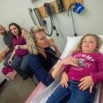 Dr. Jessica Colwell examines Azila Black, 3, as her parents Ryan and Amber Black look on at North Olympic Healthcare Network. Photo by Jesse Major/Peninsula Daily News