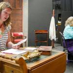 Kait Saffold, left, and Sharon DelaBarre reading through the letters they transcribed by hand from the script on a set under construction. Photo courtesy of Olympic Theatre Arts