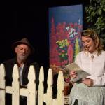 First time actress Kait Saafold reads a letter in her garden as Joe Schulz fixes a fence as an arborist in OTAs Immigrant Garden – Letters. Sequim Gazette photo by Matthew Nash