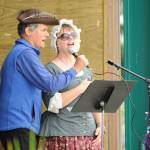 Joel Yelland and Karla Messerschmidt-Morgan help lead the The Star Spangled Banner, while the Sequim City Band plays to open the July 4 A Patriotic Fourth concert.