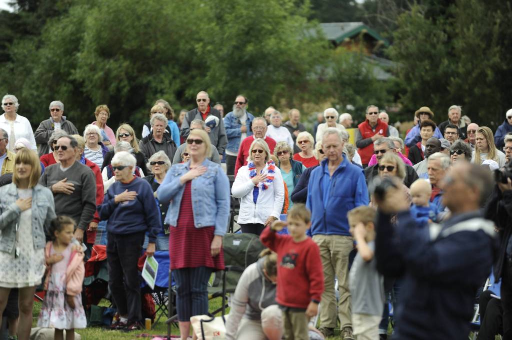 Concert-goers join in the singing of The Star Spangled Banner at the Sequim City Bands July 4 concert. Sequim Gazette photo by Michael Dashiell