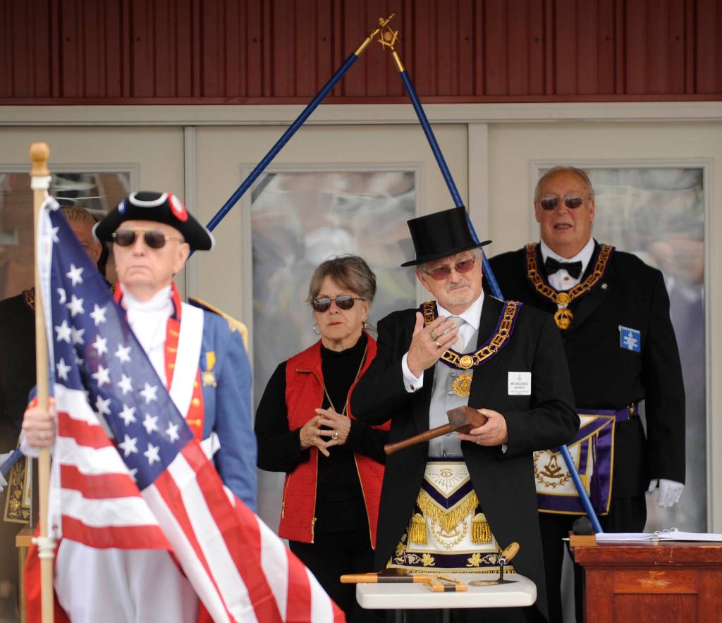 Freemasons Grand Master Charles Wood asks dignitaries to help lay the cornerstone at the grand opening of the Sequim Museum & Arts facility on July 6. Museum executive director Judy Reandeau Stipe is behind Wood. Sequim Gazette photos by Michael Dashiell