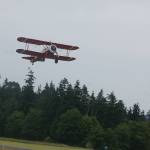 The Red Stearman biplane takes off with retired Navy medievac nurse Janet Ford on its way to fly over The Lodge At Sherwood Village. Clint Cawley flew Ford and seven other Lodge residents on July 9 from Sequim Valley Airport as part of the Ageless Aviation Dreams Foundation experience that Lodge and airport representatives set up for them. Sequim Gazette photo by Conor Dowley.