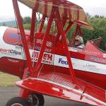 Clint Cawley of the Ageless Aviation Dreams Foundation taxis the Red Stearman biplane in at the Sequim Valley Airport as retired Air Force veteran Ken Leuthold gives an emphatic thumbs-up. Sequim Gazette photo by Conor Dowley.