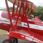 Clint Cawley of the Ageless Aviation Dreams Foundation taxis the Red Stearman biplane in at the Sequim Valley Airport as retired Air Force veteran Ken Leuthold gives an emphatic thumbs-up. Sequim Gazette photo by Conor Dowley.