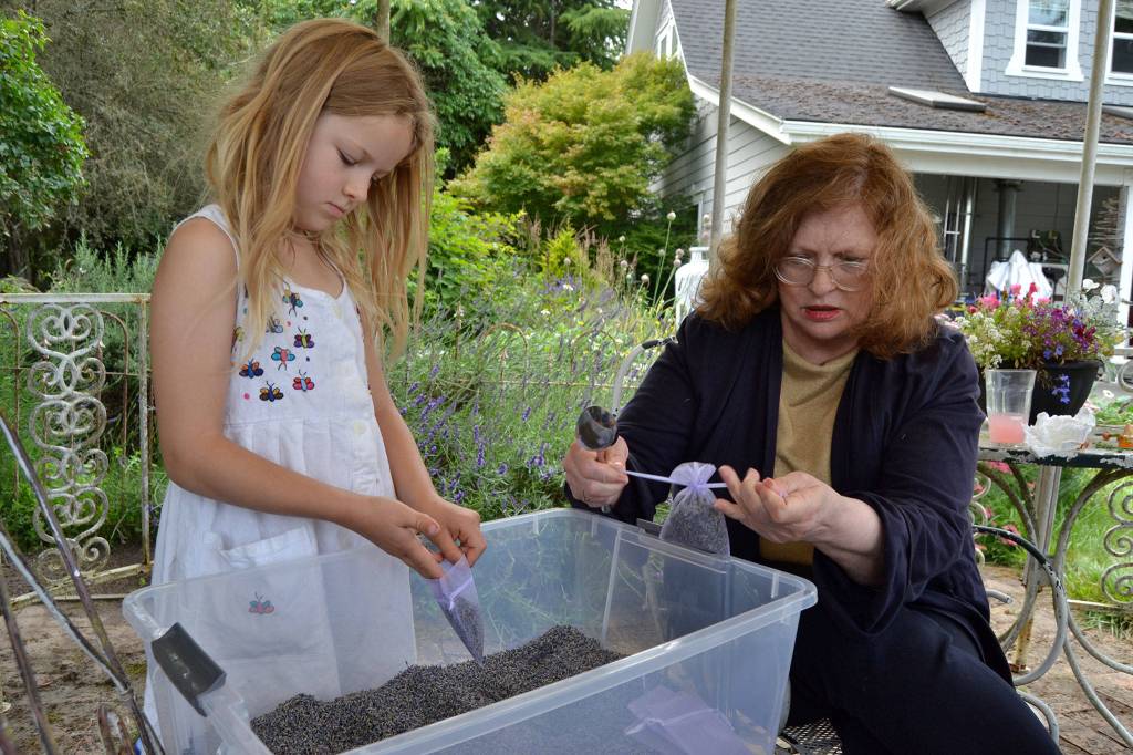 Lucca Schiefen and her grandmother Barbara Brown of San Francisco ready sachets on Monday for a busy weekend of visitors to Jardin du Soleil Lavender Farm. The farm partners with Olympic Lavender Farm to host two festivals for the price of one July 19-21 during Sequim Lavender Weekend. Sequim Gazette photo by Matthew Nash