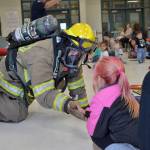 Firefighter/EMT John McIntyre high fives Hannah Baublits, 5, during Firefighter storytime. She was one of 16 children Bibity Bopity to attend the Sequim Librarys Summer Reading Program. Sequim Gazette photo by Matthew Nash
