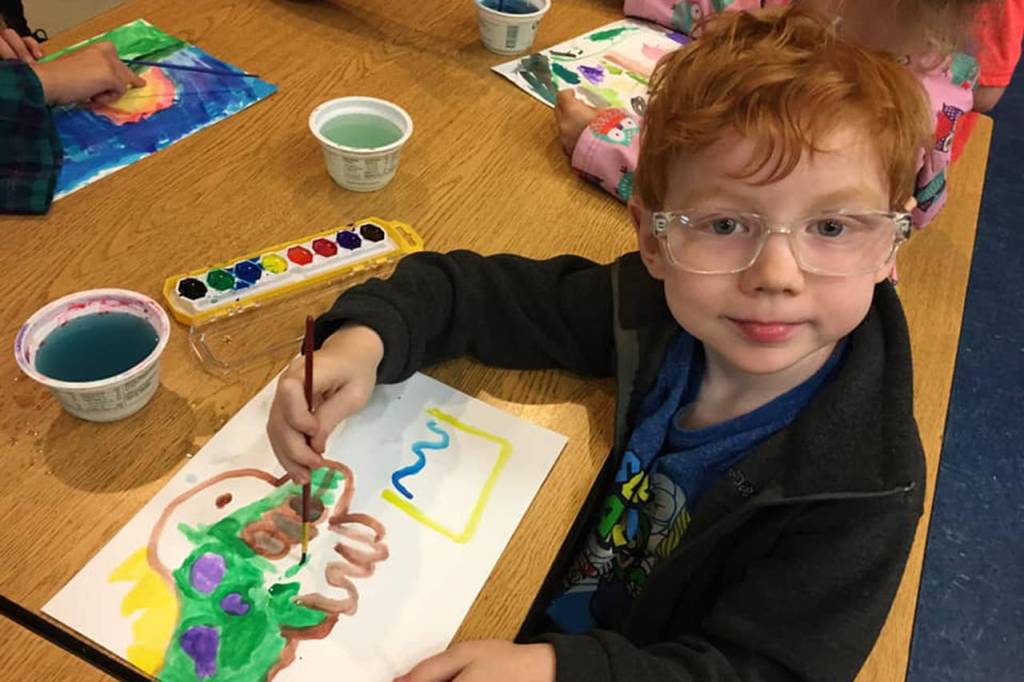 William Cottington looks up from his watercolor painting in progress in the Boys & Girls Club in Sequim. The painting and other artistic activities were part of the Clubs morning camp activities last week. Photo submitted.