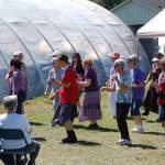 A group of visitors learns a line dance during a Lavender Festival event at Victors Lavender. Sequim Gazette photo by Conor Dowley.